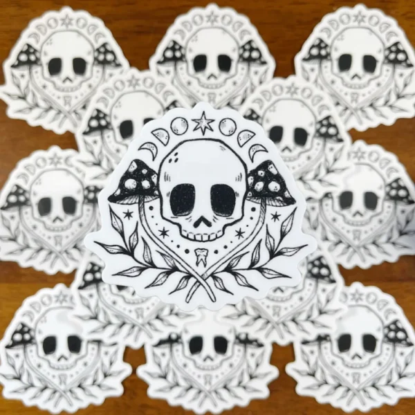 A group of skulls with trees and stars around them.