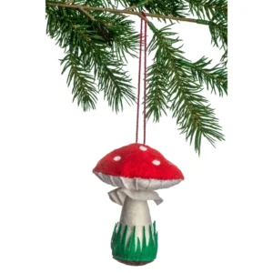 A red and white mushroom ornament hanging from a tree.