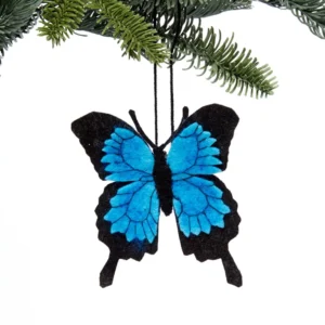 A blue butterfly ornament hanging from a tree.