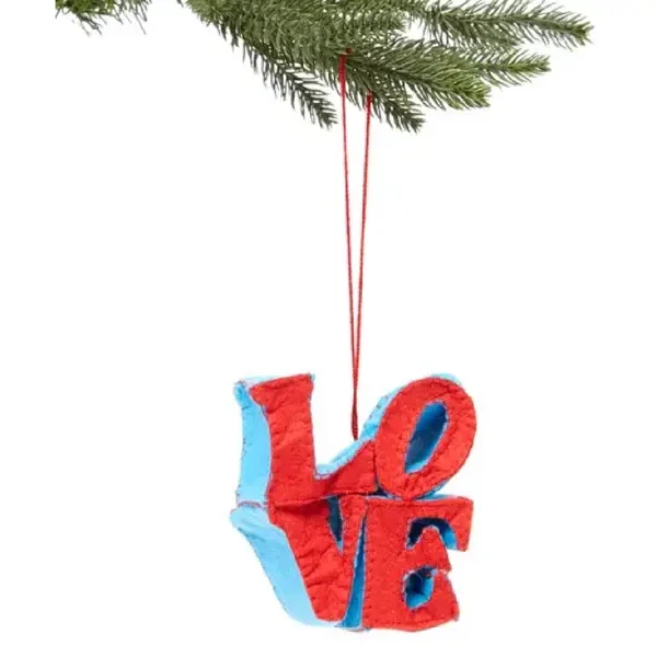 A red and blue love ornament hanging from a christmas tree.