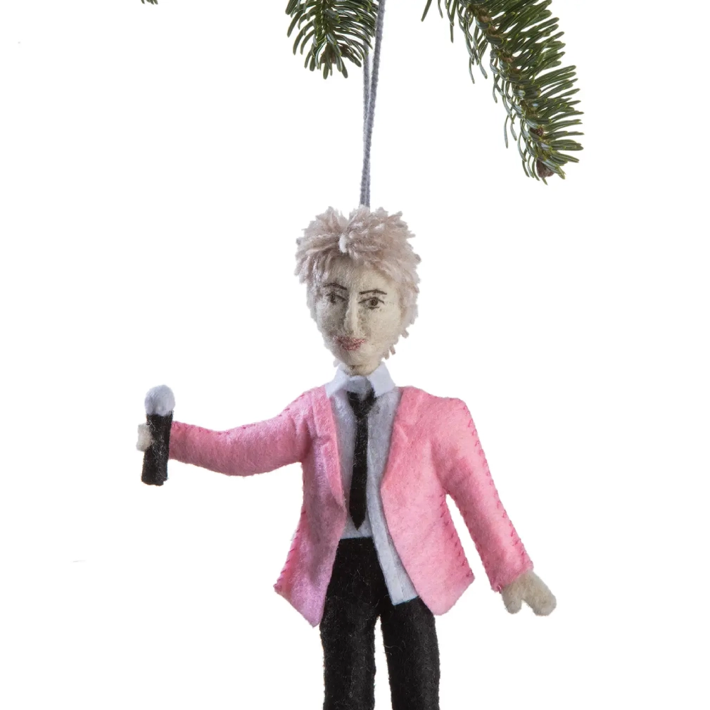 A pink suit and tie ornament hanging from a tree.