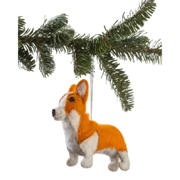 A corgi ornament hanging from a tree branch.