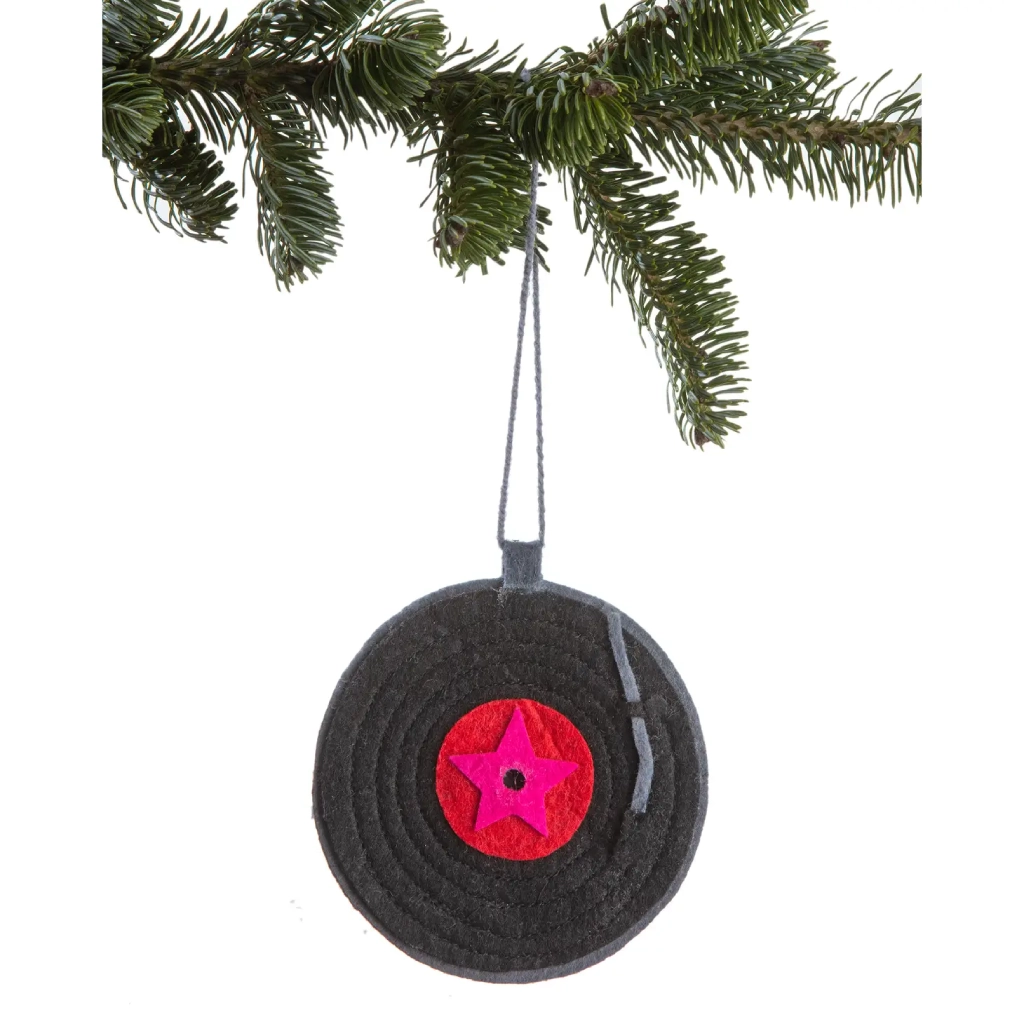 A black record hanging from a christmas tree.