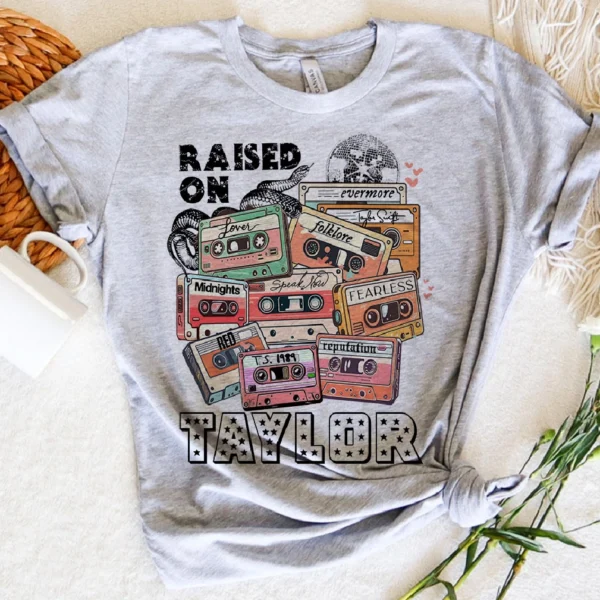 A t-shirt that says raised on taylor with some tapes